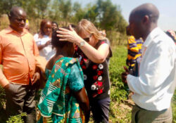 Praying for a new Christian in an agricultural project on the outskirts of Kigali