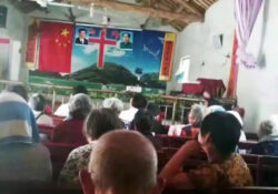 Images of Mao and Xi flank a cross in a Chinese church